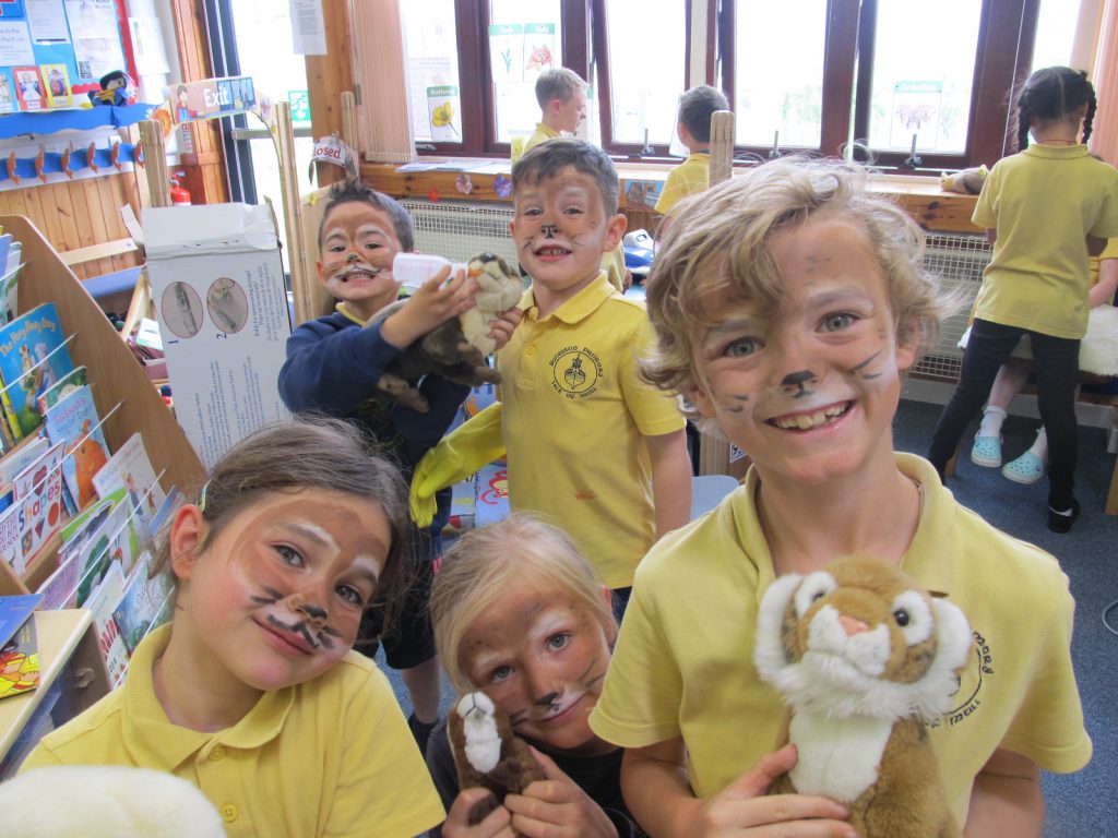 Children with painted otter faces